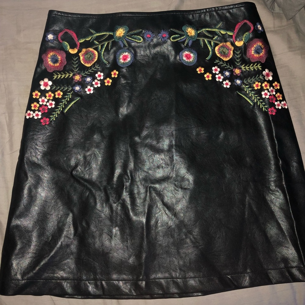 Black leather skirt with floral detailing